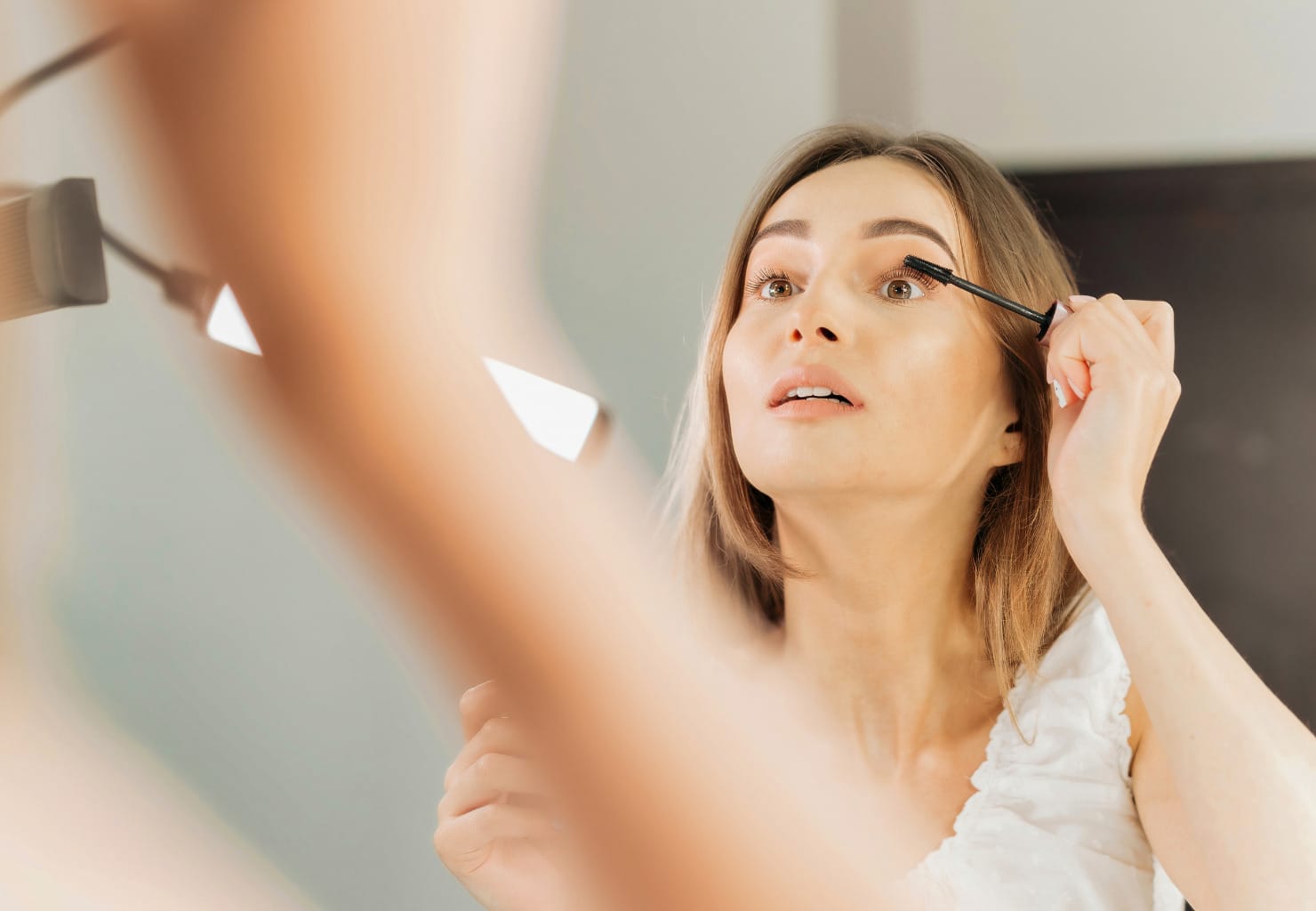 Woman putting on makeup eye makeup