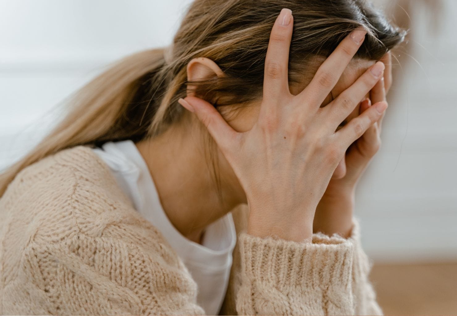 stressed young woman head in hands