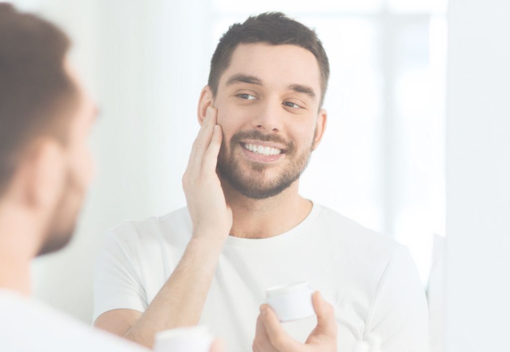 man applying skincare